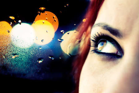 Colorful image detail of girl looking and abstract city lightsの写真素材