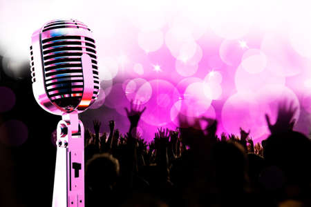 Live music background.Vintage microphone and publicの写真素材
