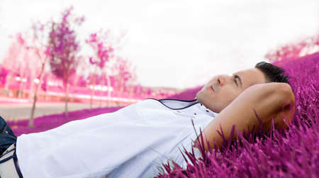 Man portrait lying on the grass.Dreamscapeの写真素材