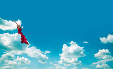 Woman sitting on the cloud. Happiness and joy concept.