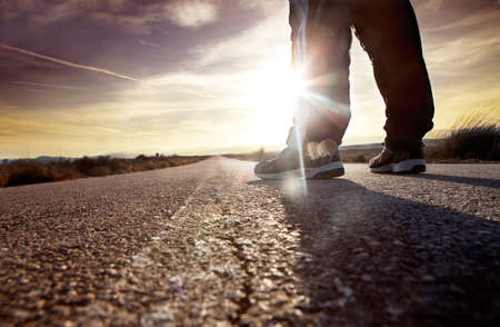 anonymous man on the road and sunset landscape.travel conceptの写真素材