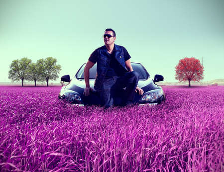 Surreal landscape and man portrait and his car.Leisure and recreation.Car conceptの写真素材