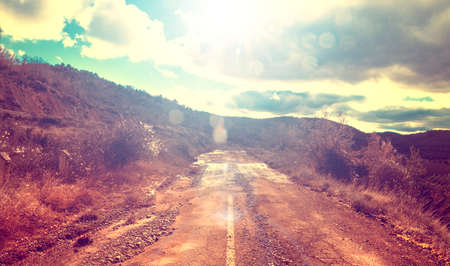 Asphalt and travel concept.Old road and sunset.Vintage styleの写真素材