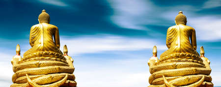 Golden Buddha statue over blue sky background.Asian and buddhist cultureの写真素材