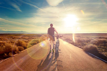 Bike and adventures lifestyle.Bicycle rider and road scenicの写真素材