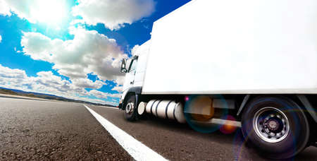 Truck and transport. Lorry delivering freight by road or highwayの写真素材