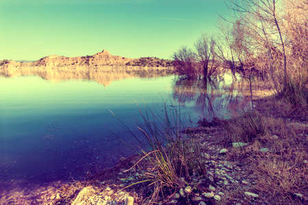 Lake scenery sunset in vintage style filter.Shore and trees.の写真素材