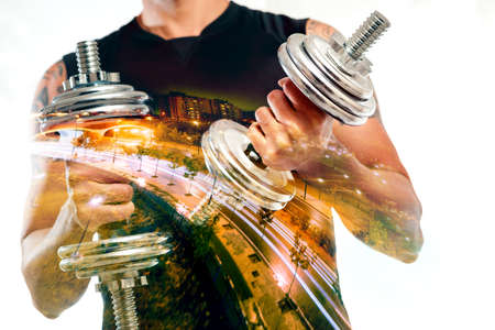 Gym equipment and sport concept.Double exposure background.Dumbbells.の写真素材