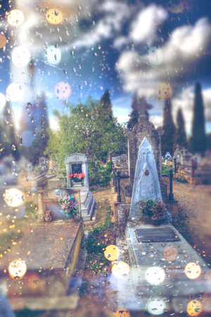 Abstract concept of death and passage of time with grave in the cemetery on rainy dayのeditorial素材