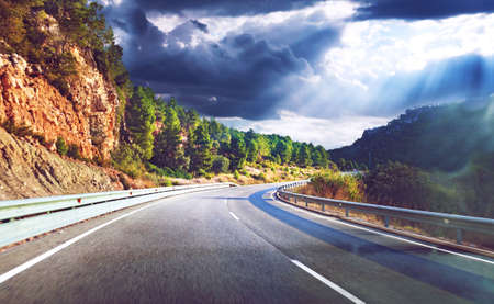 Road and travel concept.Sunset landscape and mountains.Highway to destiny.Tranquility and safety drivingの写真素材