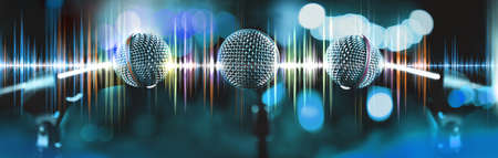 Musical design,Karaoke concept.Microphone and sound waves.Live music and blurred stage lights. Music backgroundの写真素材