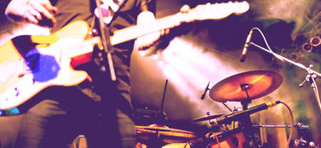 Live music and rock band on stage.Abstract musical background. Playing guitar and music concert concept.の写真素材