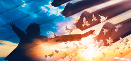 Evangelical Christian music concept background. Musical design with piano and sunset landscape with white dovesの写真素材