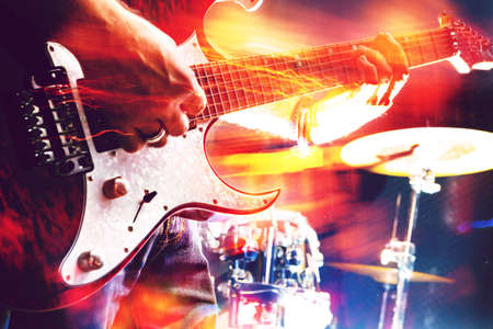 Playing guitar and concert concept.Live music background.Music festival.Instrument on stage and bandの写真素材
