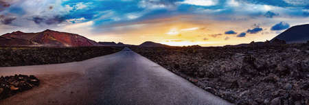 Road through the scenic landscape to the destination in Timanfaya natural park in Lanzarote,Canary island,Spainの写真素材