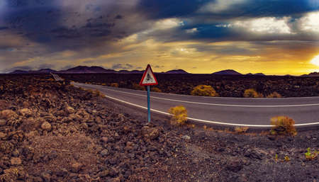 Road through the scenic landscape to the destination in Timanfaya natural park in Lanzarote,Canary...