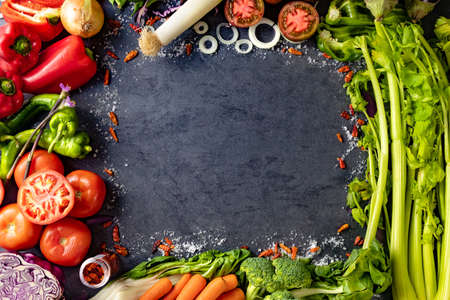 Healthy foods. Vegetables and fruits collection on black cement or stone background. Top view and copy space.の写真素材