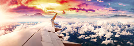 Airplane and scenic sunset.Vacations and tourism flying around the world.