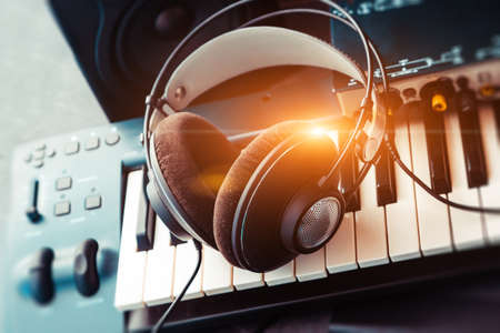 Keyboard or synthesizer with headphones and sound card. Computer recording and music production concept.の写真素材
