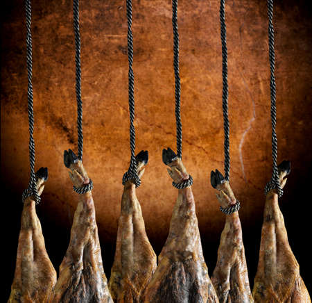 Slicing Spanish iberic ham. Spanish ham and traditional food. Dry Spanish ham, Jamon Serrano, Bellota, Italian Prosciutto Crudo or Parma ham.の写真素材