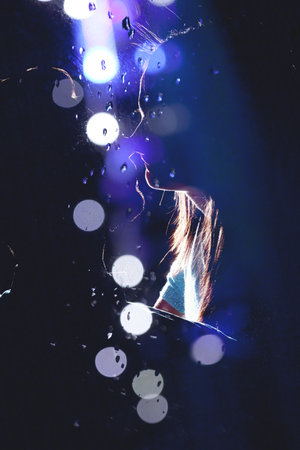 Silhouette Romantic couple embraces and kisses in the night and city lights.の写真素材