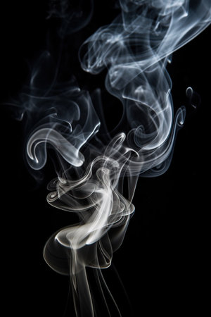 Abstract backdrop with stains of white incense smoke over black background.の素材