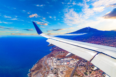 Aerial view of the sky over the mountains and the peak of the Teide volcano from the window of an airplane.の写真素材