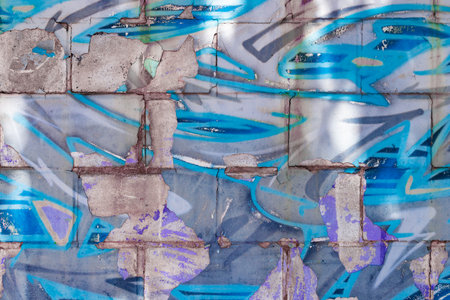 Block wall background spray painted in blue tones.の写真素材