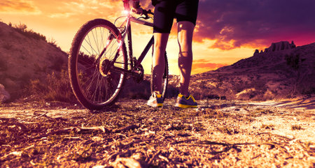 Dreamy sunset and healthy life.Autumn fields and bicycle.の写真素材