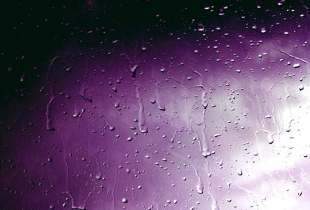 Street view through the wet glass in rainy day. Storm in the city through wet window. Autumn related.の写真素材