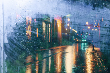 Abstract background of night city street raining through the windowの写真素材