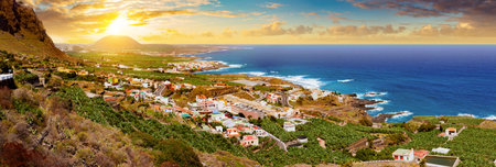 Spain beaches. Sunset panorama village coast and field of banana trees in Tenerife.の写真素材