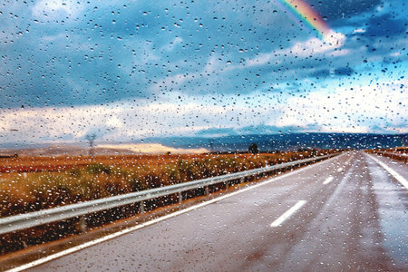 Abstract image of car and road through the wet window.の写真素材