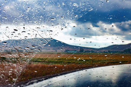 Abstract image of car and road Through the wet window.の写真素材
