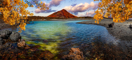 Red mountain and green puddle near the sea coast in Canary island,Lanzarote.Spain beaches.の写真素材