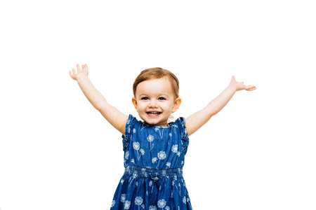 very happy toddler girl with arms outstretched up and a victorious smileの写真素材