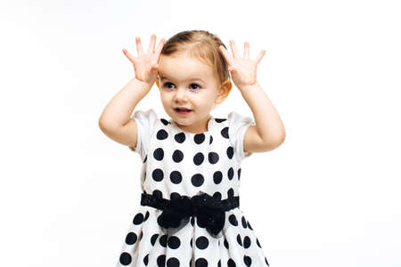 toddler girl with hands up showing ten fingersの写真素材