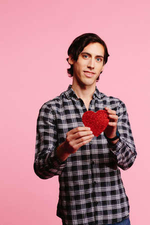 Sweet guy in checkered shirt offering red heart, Valentine's dayの写真素材