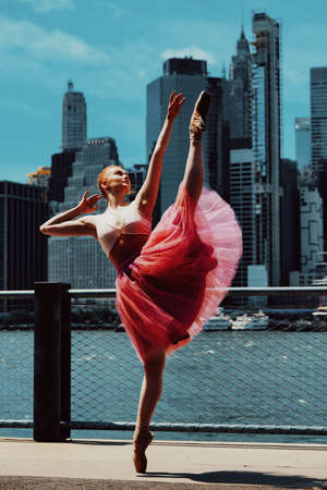 elegant ballerina in dress dancing with New York City downton cityscape on backgroundの写真素材