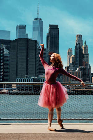 redhead young girl posing at city street downtown New York City financial districtの写真素材