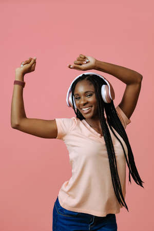 Beautiful young woman dancing and listening music in headphonesの写真素材