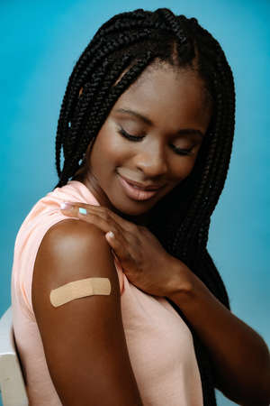 Vaccinated attractive young woman with plaster on handの写真素材