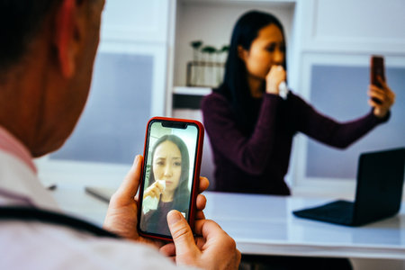 doctor and sad female patient discussing something using smartphones in hospital
