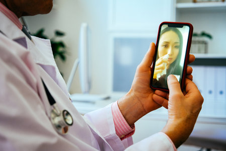 doctor and sad female patient discussing something using smartphones in hospital