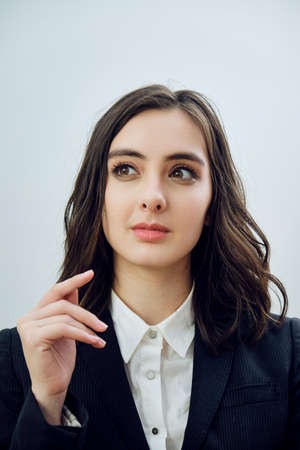 close up portrait of a beautiful young businesswoman wearing black jacket on a white background...