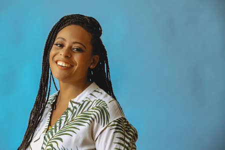 closeup portrait of smiling young beautiful african american woman braid hair posing at studio...