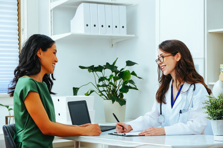Female doctor smiling with woman patient consultation clinic health checkupの写真素材