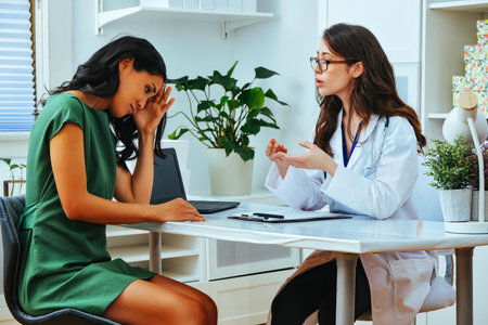 female doctor explaining treatment to worried patient at health checkupの写真素材