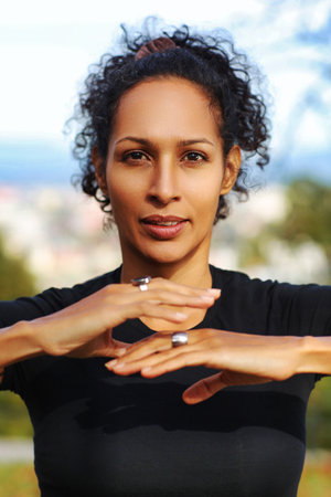 close up woman outdoors with earphones and curly hairの写真素材