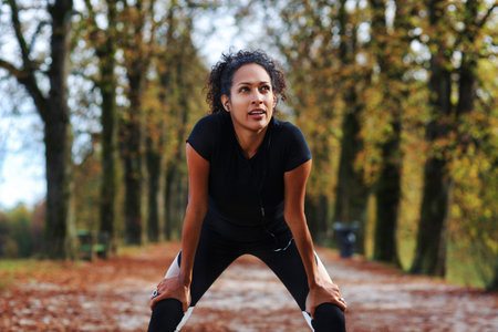 positive woman stretching outdoors preparing for exerciseの写真素材
